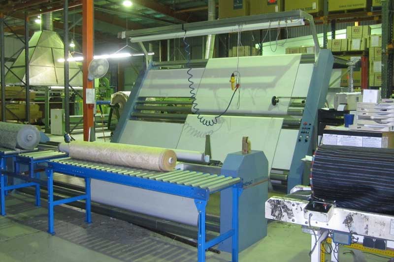 Delta 3 machine with rear roll up, inspected rolls entering plastic wrapping tunnel. Dual sided inspecting being used.